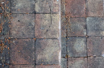 worn square tile. shades of brown and black. picturesque dark background