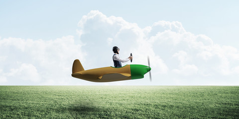 Happy aviator driving small propeller plane