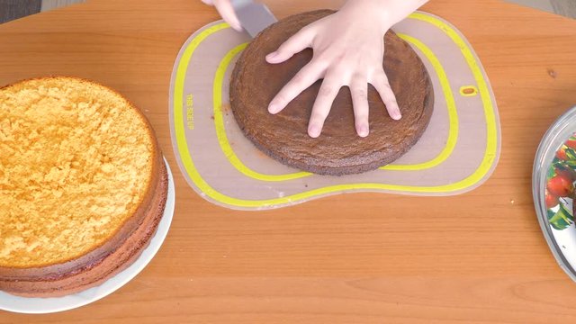 cuts a cake of light green color into two halves