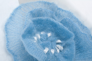 Fototapeta premium Knitting mohair wool and knitting needles for handmade on wooden table. Blue Flower.