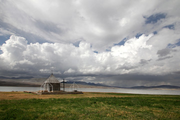 Small church under a huge white cloud in the village of Foka. © Nadzeya