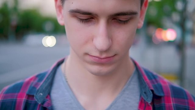 Sadness guilt or shyness. Insecure embarrassed expression. Closeup portrait man looking down.