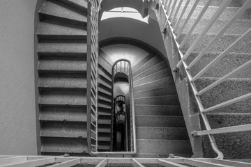 The detail of the old staircase inside the old vintage house. Black and white picture. 