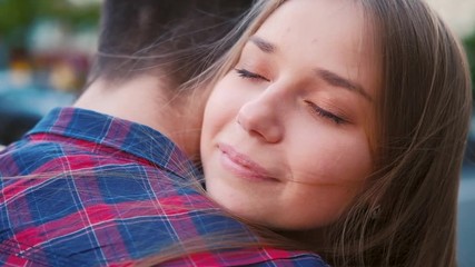 Love happiness and sincere feelings and emotions. Closeup of young couple hugging in the street.