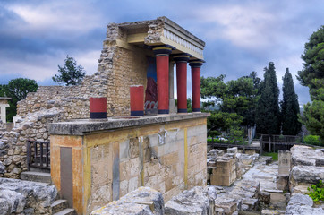 Knossos Palace, Crete / Greece. Restored North Entrance with charging bull fresco at the famous archaeological site of Knossos. Sunset, cloudy sky