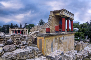 Knossos Palace, Crete / Greece. Restored North Entrance with charging bull fresco at the archaeological site of Knossos. North Lustral Basin room in the background. Sunset, cloudy sky
