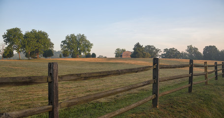 "Bailing Hay Today" a field of freshly cut hay at dawn with wooden fence Zen Duder Americana Fences Collection