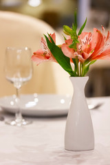 Table setting with flowers in restaurant