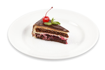 Slice of cake with cherry on a plate isolated on a white