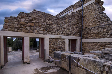 Knossos, Crete - Greece. Knossos Palace at the archaeological site of Knossos which is the largest Bronze Age archaeological site on Crete and has been called Europe's oldest city. Sunset, cloudy sky