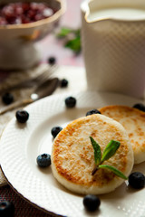cheesecakes with blueberry cream and jam on the table