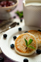 cheesecakes with blueberry cream and jam on the table
