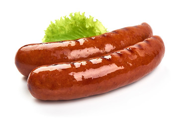 Grilled pork sausages with lettuce, close-up, isolated on white background
