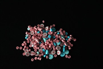 Pink and Blue paper quilled tight coil circles against black background