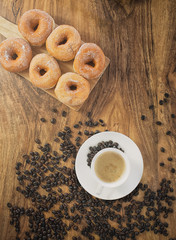 Coffee cup and roasted coffee beans. on wooden background.