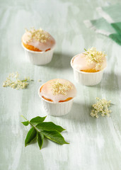 Delicious homemade cupcakes with elderberry flowers and sugar icing. Selective focus.