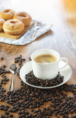 Coffee cup and roasted coffee beans. on wooden background.