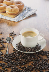 Coffee cup and roasted coffee beans. on wooden background.