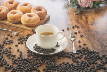 Coffee cup and roasted coffee beans. on wooden background.