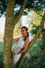 Bride portrait shooting next to a tree with green background