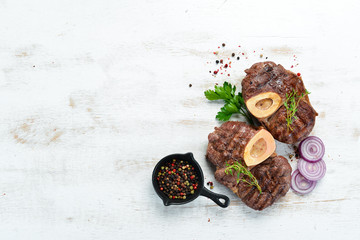 Beef shank roasted on a grill on a white background. Top view. Free space for your text.