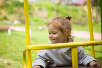 Fototapeta premium the baby leaned on the swing and quite basked in the sun