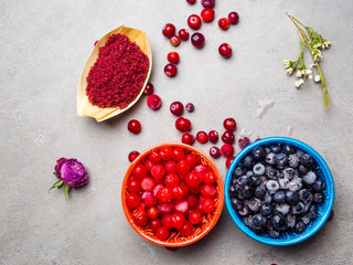 frozen blueberry, viburnum, cranberry in bowls, decorated with dry flowers, leafs