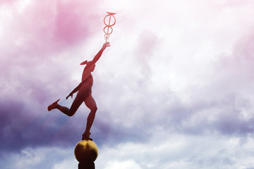 Mercury Hermes god statue running trough clouds in winged sandals, caduceus in hand. Commerce,...