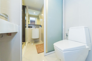 Condo bathroom design with single vanity cabinet and grey tiles on the walls.