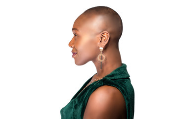 Beautiful black African American female model posing confidently with bald hairstyle on a white...