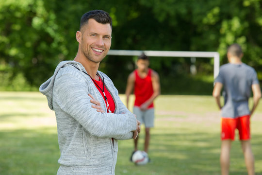 Male Football Coach Posing And Smiling