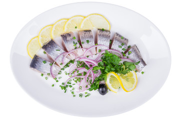 Isolated pieces of herring in a plate