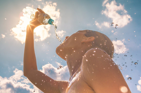 Woman Drinking Cooling Off In The Summer Heat 