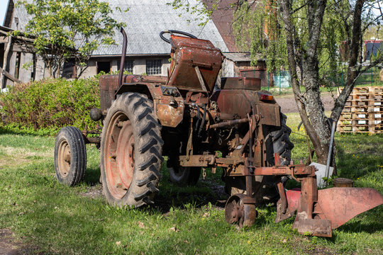 Old tractor on the background of the countryside