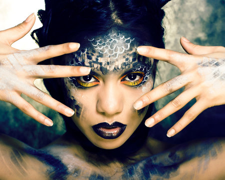 fashion portrait of pretty young woman with creative make up like a snake, halloween concept closeup