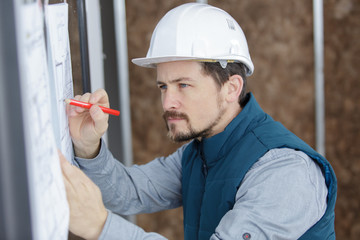 architect working on blueprint plans