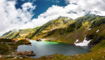 Fototapeta na wymiar amazing mountain scenery. lake in mountains with clouds reflecte