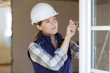 female window fitter using screwdriver