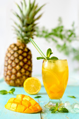 Fototapeta na wymiar Yellow iced tea with pineapple, lemon