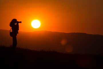 Fototapeta na wymiar Silhouette of the photographer at sunset.