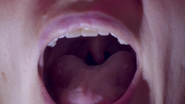 adult girl opened his mouth and shows throat at the doctor's reception