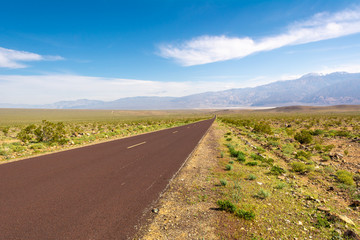 Fototapeta premium Trona Wildrose Road that leads to the Death Valley in California on a beautiful sunny day with blue sky and mountains in the background.