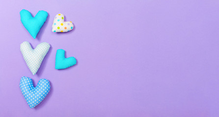 Heart cushions in Valentine's day theme on a purple paper background