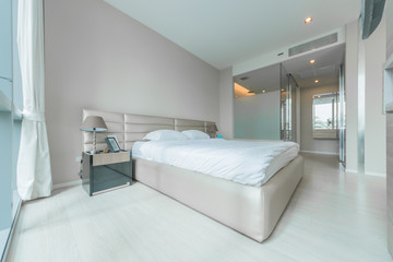 Open spacious bedroom with modern stylish furniture.