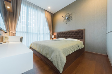 Open spacious bedroom with modern stylish furniture.