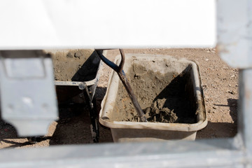 Big bucket full of fresh cement just mixed.