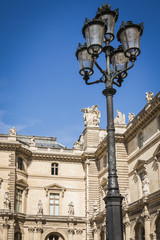 Fototapeta na wymiar Architectural facade of the aisles and the lamps of the place of the pyramids of the Louvre museum in Paris - Paris, France