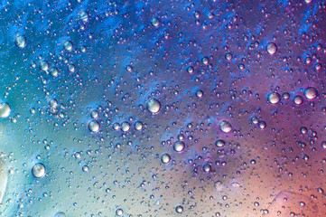 Abstract textured neon background galaxy slime with air bubbles inside. Macro of kids toy slime.
