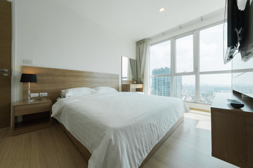 Fototapeta na wymiar Warm bedroom interior with a comfy bed,