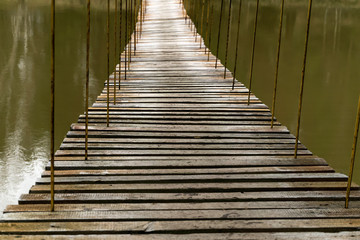 Fototapeta na wymiar suspension bridge over cold water